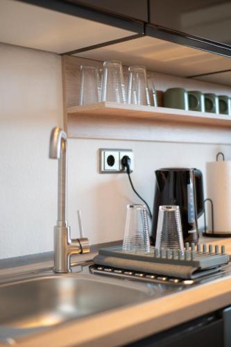 a kitchen counter with a sink and a coffee maker at Comfortable 3 room apartment I 81 m2 I Central l Self-Check-In I Elevator & Balkony in Hannover