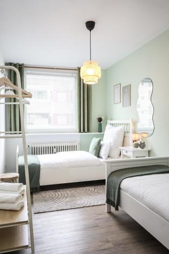 a bedroom with two beds and a ladder at Comfortable 3 room apartment I 81 m2 I Central l Self-Check-In I Elevator & Balkony in Hannover