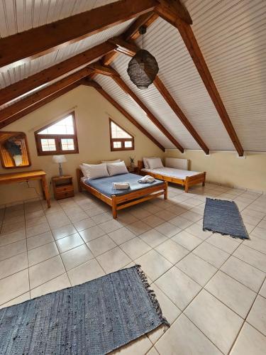 a large room with a bed and a table at Cedar House a Greek treasure in Sami
