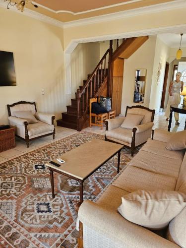 a living room with a couch and a table at Cedar House a Greek treasure in Sami