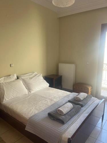 a bedroom with a bed with towels on it at Cedar House a Greek treasure in Sami