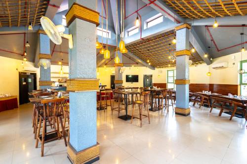a restaurant with tables and chairs in a room at BUDDHA HERITAGE RESORT in Bodh Gaya