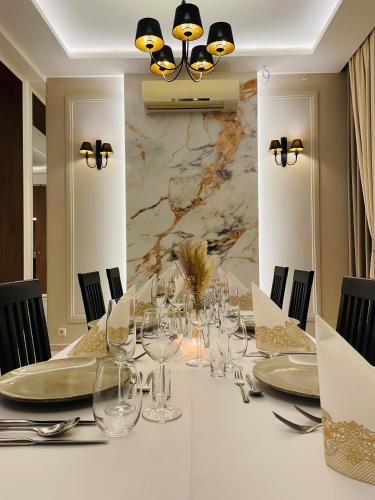a dining room with a long table with glasses at Hotel Pod Chełmem in Ropa