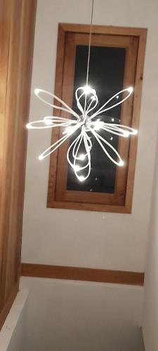 a ceiling chandelier in a room with a window at Casa Augusto Stunning view in Trindade