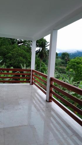 a balcony of a house with a view of trees at Casa Augusto Stunning view in Trindade