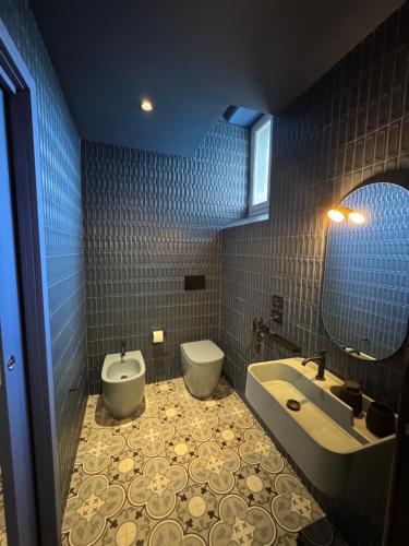 a bathroom with a tub and a toilet and a sink at Don Raffaé in Nola