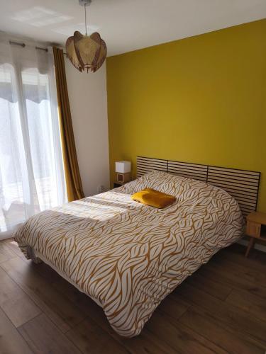 a bedroom with a bed with a zebra print blanket at Gîte du Bois in Viry-Noureuil