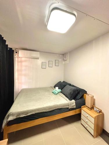 a bedroom with a bed with a light on the ceiling at House in Davao in Davao City