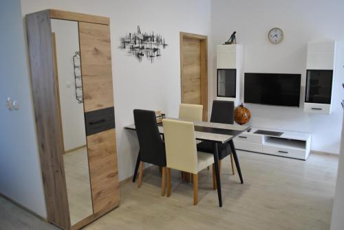 a dining room with a table and chairs at Prenočišča Dany APARTMA 1 in Dravograd