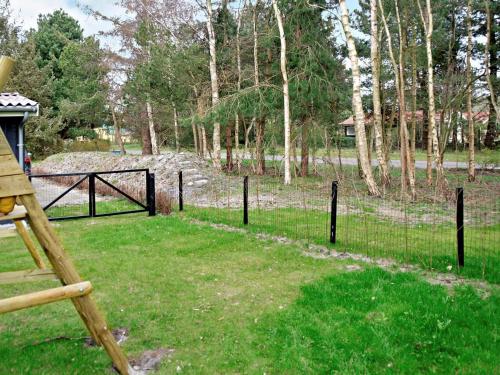 a fence in front of a field with trees at Family Haven in Kramnitze - By Traum Ferienwohnungen in Kramnitse