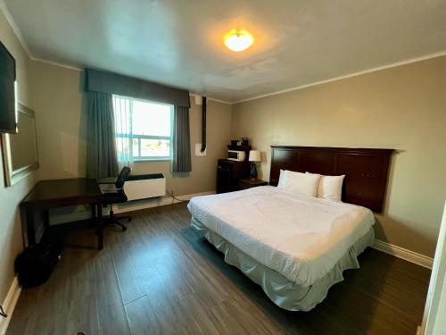 a hotel room with a bed and a desk at London residency inn in London
