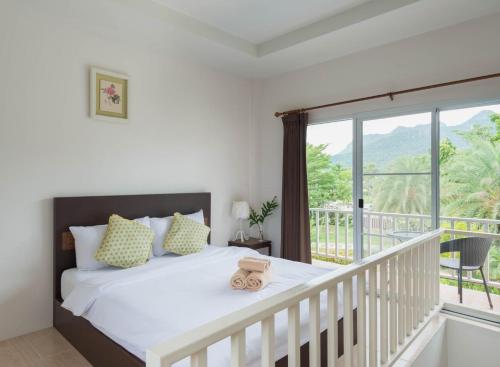 Ένα ή περισσότερα κρεβάτια σε δωμάτιο στο Sweet Honey Resort, Pranburi - Hua Hin