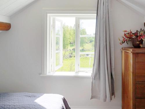 a bedroom with a bed and a window at 5 person holiday home in Mellösa in Mellösa