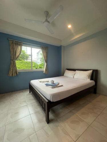 a bedroom with a large bed with a window at Bonita House in Bangkok
