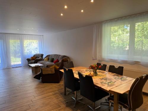 a living room with a table and chairs at Modern & barrier-free with garden in Hückelhoven