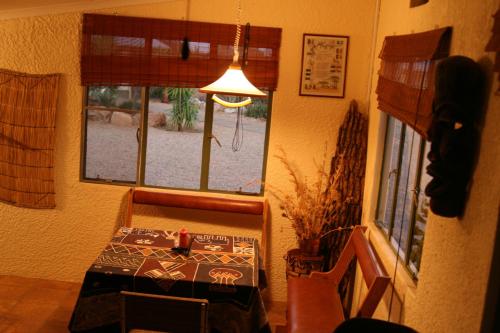 a dining room with a table and a window at Etango Ranch Guest Farm in Voigtland
