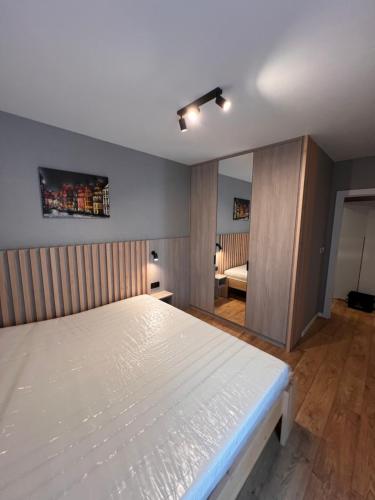 Katil atau katil-katil dalam bilik di Apartament Dominikanów 28m36