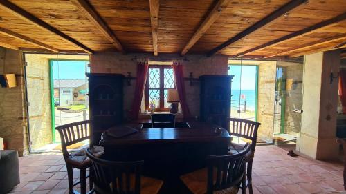 a dining room with a wooden table and chairs at Villa Bellavista in Kavarna