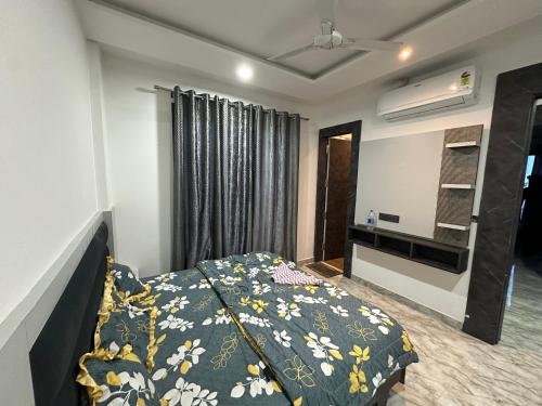 a bedroom with a bed and a flat screen tv at Hotel Diamond Touch in Sirhind