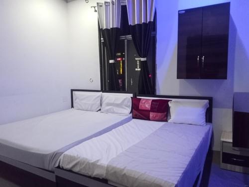 Ένα ή περισσότερα κρεβάτια σε δωμάτιο στο hotel pink city