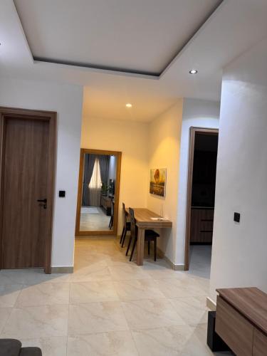 a living room with a table and a dining room at D-GioGiNiapartments in Gwarinpa