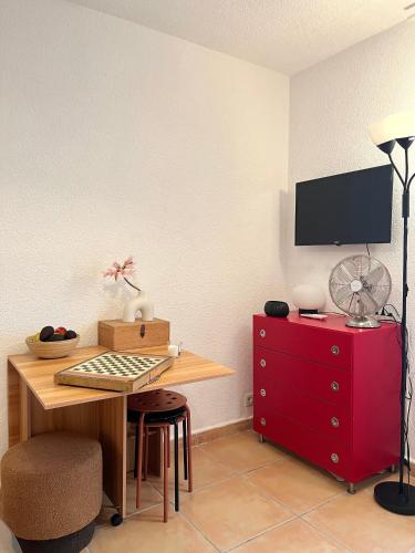 a room with a desk and a red dresser at Maisonette in Saint-Raphaël
