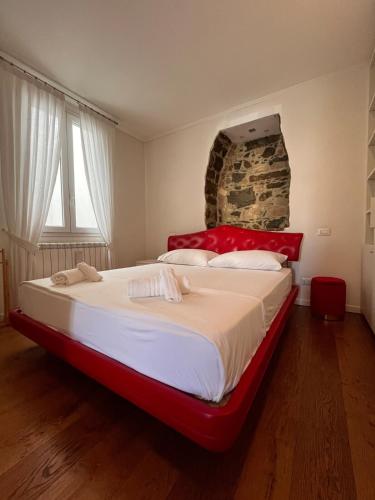 a large bed in a room with a stone wall at RivApartments2 FREE private parking in Trieste