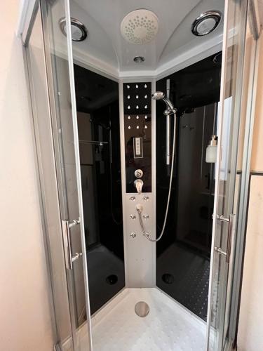 a shower with a glass door in a bathroom at RivApartments2 FREE private parking in Trieste
