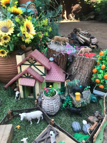 a toy house with a farm and animals and flowers at African Diamond - Date Night Suite in Benoni