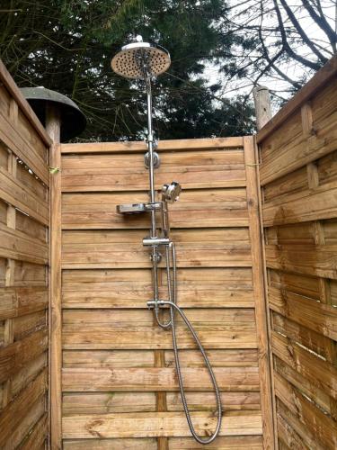 a shower is attached to a wooden fence at Swallows Oast Glamping in Sedlescombe