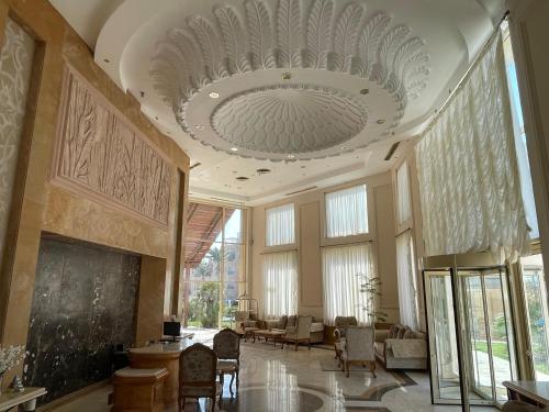 a large room with a large ceiling and windows at Shams Prestige Abu Soma (Adults Only) in Hurghada