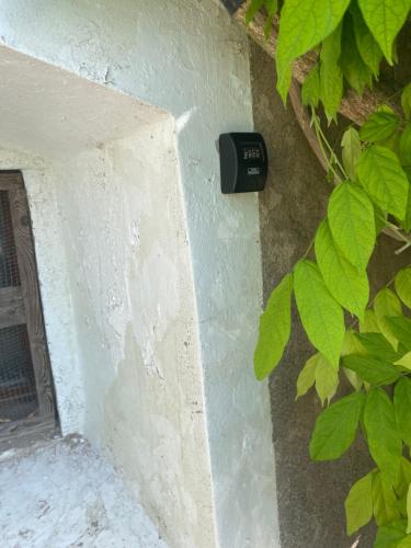 a black mailbox on the side of a wall at Cosy italien house for 8 people 5 min from Lago di Garda in Riva del Garda
