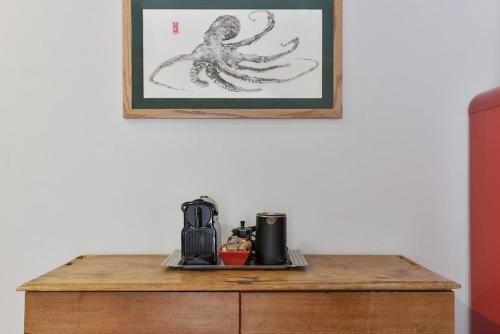 a table with an octopus drawing on the wall at Casa Gyotaku in Bagnaia