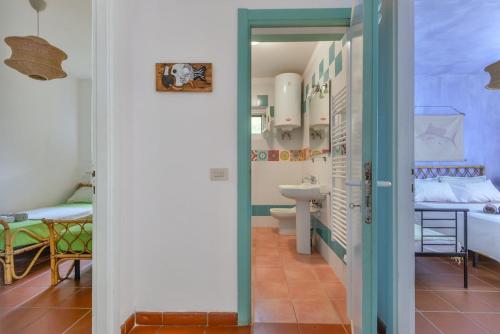 a bathroom with a sink and a toilet in a room at Casa Gyotaku in Bagnaia