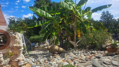 a garden with a bunch of rocks and trees at Maison entière stylée LOFT le PAS SAGE in Bouloc