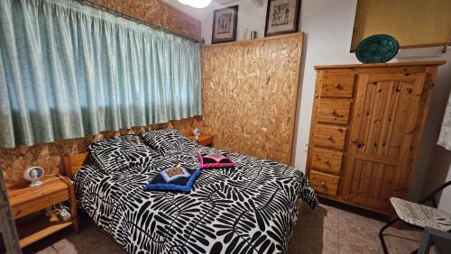 a bedroom with a black and white bed and a window at Maison entière stylée LOFT le PAS SAGE in Bouloc