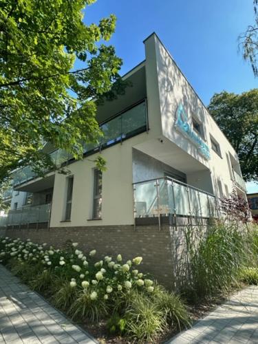 a large white building with windows on the side of it at Apartamenty Akwamaryn in Ustka