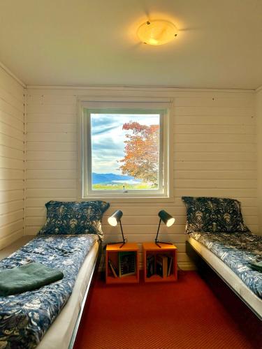 a room with two beds and a window at Cozy Landscape House, Near pulpit Rock in Strand