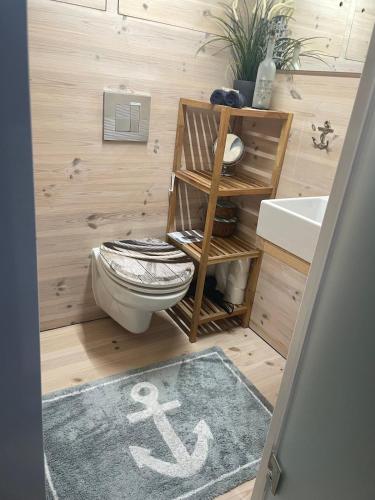 a bathroom with a toilet and a sink at Hausboot Hafenkönig Lübeck in Lübeck
