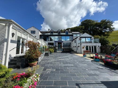 an external view of a house with a stone driveway at Ambleside Rooms & Suites in Ambleside