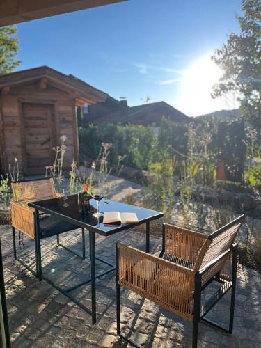 a table and two chairs on a patio at Alpinum Chalet mit privater Außensauna in Rettenberg