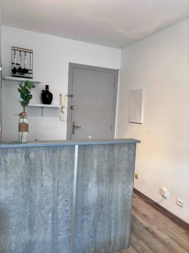 a kitchen with a concrete counter top in a room at City Break Arras in Arras