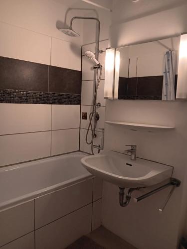 a bathroom with a sink and a bath tub at Ferienwohnung Lona in Bad Reichenhall