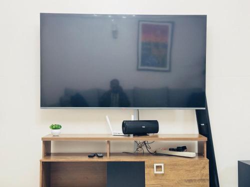 a large flat screen tv hanging on a wall at Skyhorse condo in Nairobi