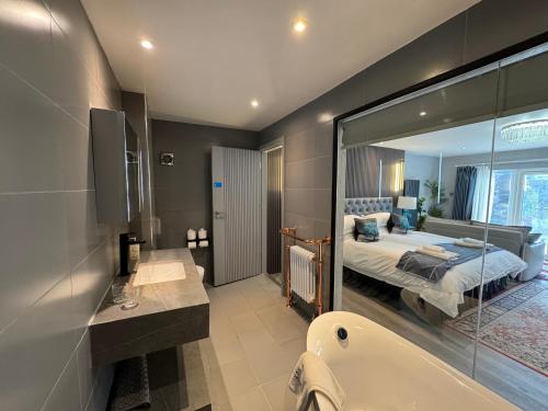 a bathroom with a bed and a bath tub and a bath tub at Ambleside Rooms & Suites in Ambleside