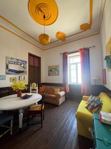 a living room with a table and a couch at Solar Das Marés in Fuzeta