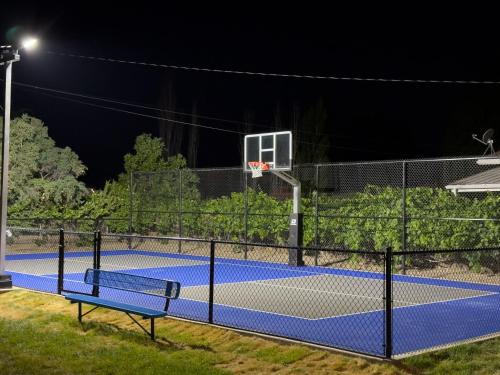 a basketball hoop on a tennis court at night at Vernal Sport-Court Base Camp in Vernal