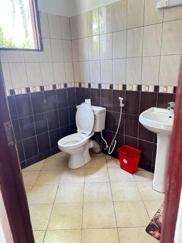 un baño con inodoro y lavabo en Private 3 Bedroom Villa - Diani, en Ukunda