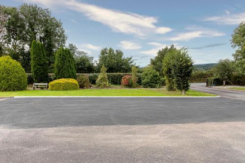an empty parking lot in front of a garden at Fernfeild in Old Twopothouse Cross Roads