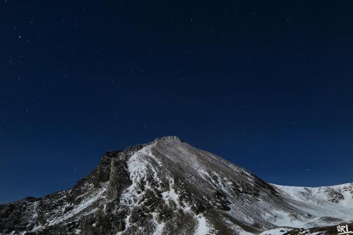 a mountain covered in snow at night with the stars at Hotel Mas de Xaxas in Camprodon